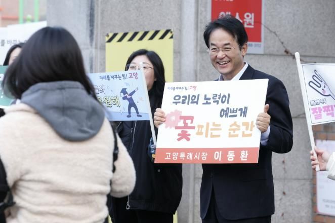 이동환 고양시장이 주엽고등학교 수능 시험장 앞에서 피켓을 들고 수험생들을 응원하고 있다.